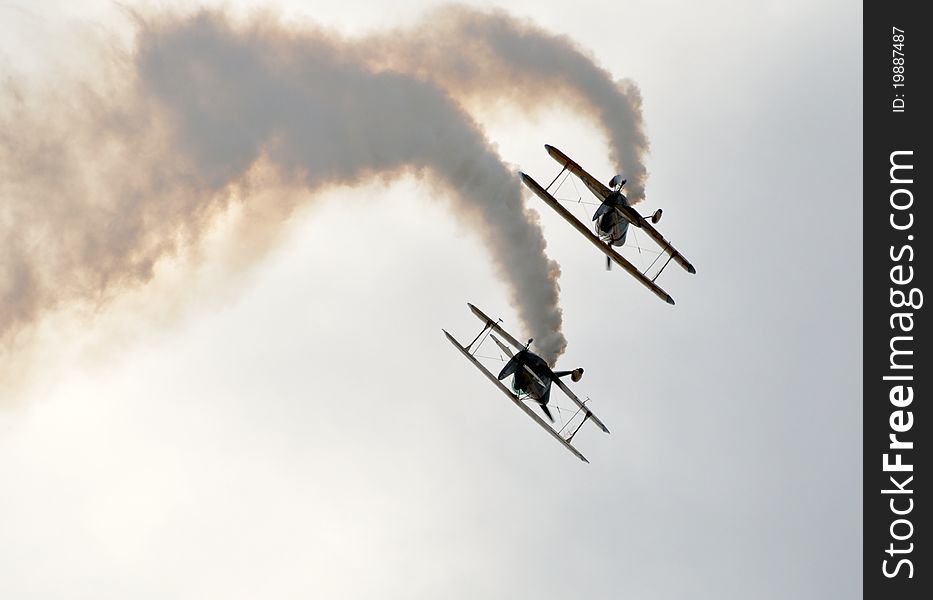 Shot of two stunt bi-planes in a tight formation roll. What I especially like about this shot is that it works all four ways up. Shot of two stunt bi-planes in a tight formation roll. What I especially like about this shot is that it works all four ways up.