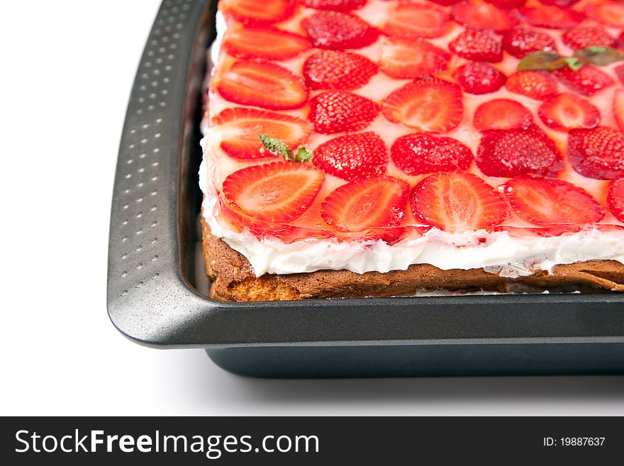 Cake with strawberries and mint on a white background