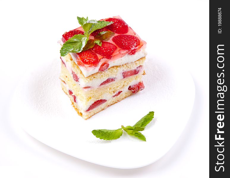 Cake with strawberries and mint on a white background