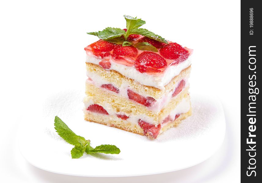 Cake with strawberries and mint on a white background