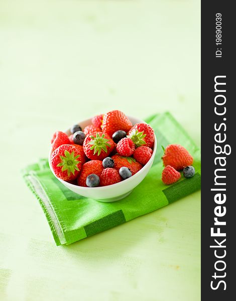 Photo of mixed fresh berries on green table by day light