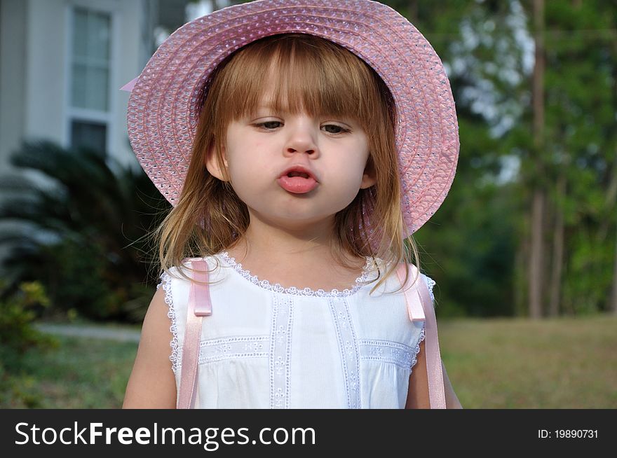 Toddler girl preparing to give a kiss. Toddler girl preparing to give a kiss.