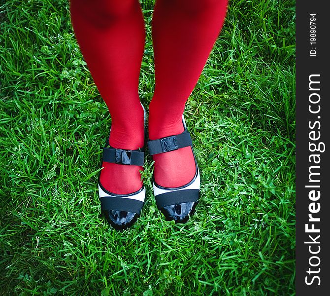 Woman's feet in shoes, against green grass. Woman's feet in shoes, against green grass