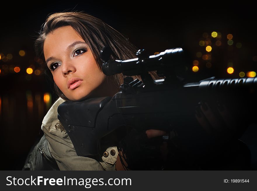 Young beauty girl with machine-gun on black background. Young beauty girl with machine-gun on black background