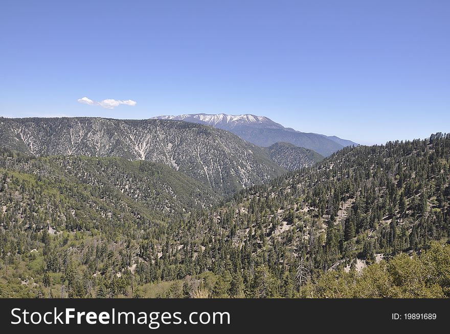 A beautiful landscape of snow capped mountains in the forest of Big Bear Lake in southern California. A beautiful landscape of snow capped mountains in the forest of Big Bear Lake in southern California