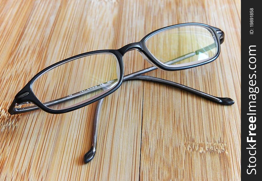 Diopter glasses on a wooden table.