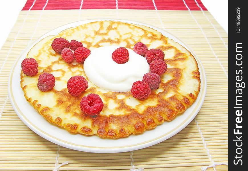 Pancake with sour cream and raspberry berries