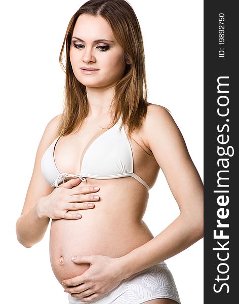 Portrait of the beautiful pregnant woman posing isolated on white