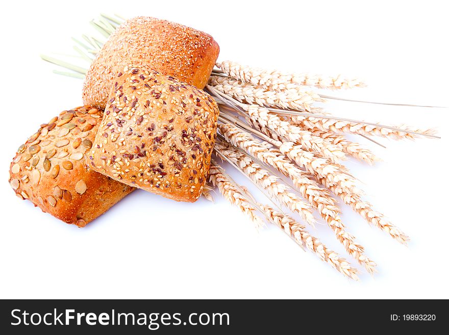 Tasty baked with ears of wheat, isolated on a white background