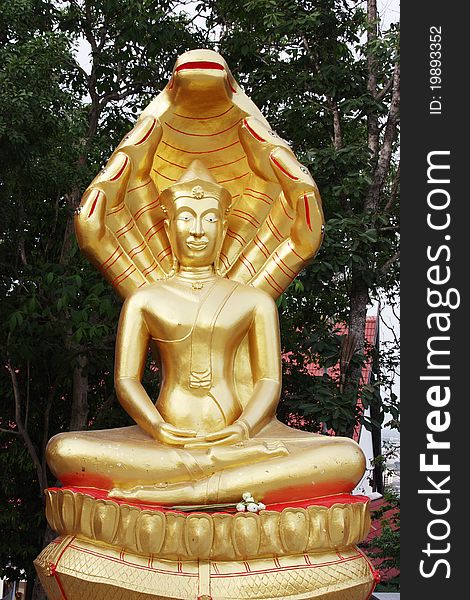 Sitting Buddha with snake shelter at a Wat in Pattaya, Thailand