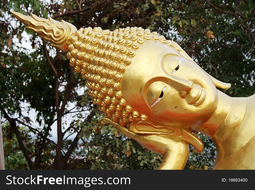 Closeup of reclining Buddha face at a Wat in Pattaya, Thailand. Closeup of reclining Buddha face at a Wat in Pattaya, Thailand