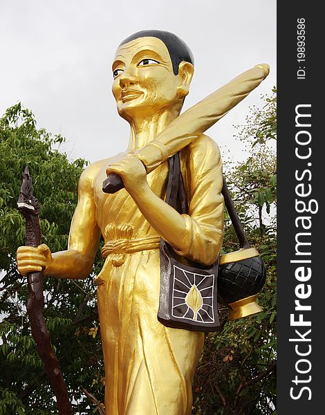 Walking Buddha with stick at a Wat in Pattaya, Thailand