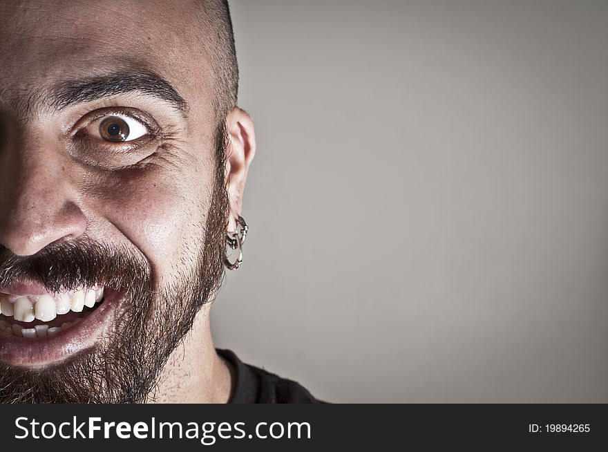 Mid-frontal portrait of smiling man on grey background