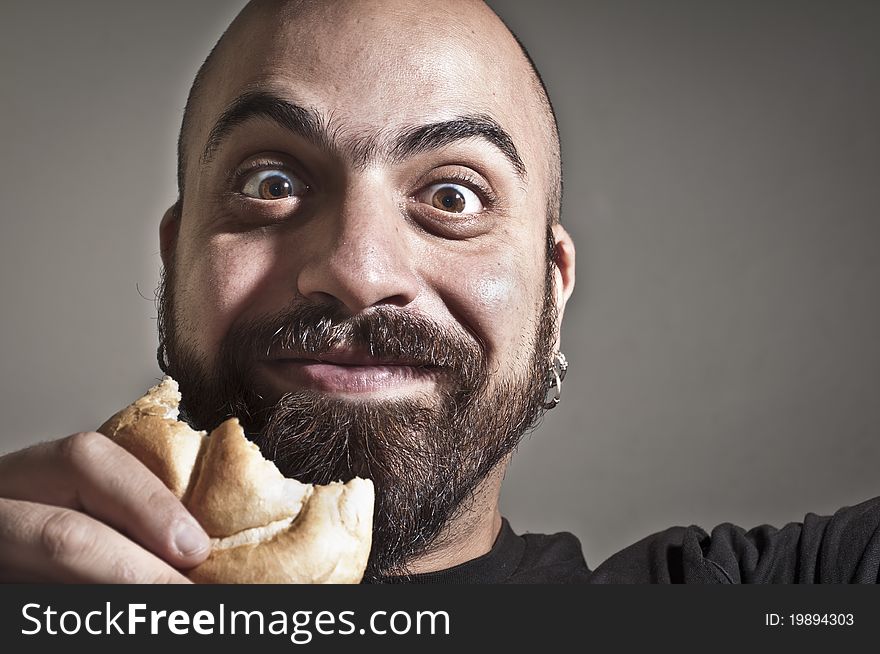 Happy man with bread in his mouth
