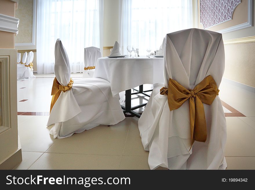 Interior of the restaurant with white table and chairs. Interior of the restaurant with white table and chairs