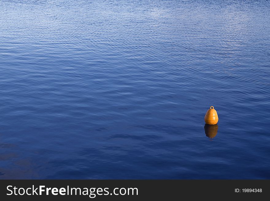 A yellow buoy in the sea