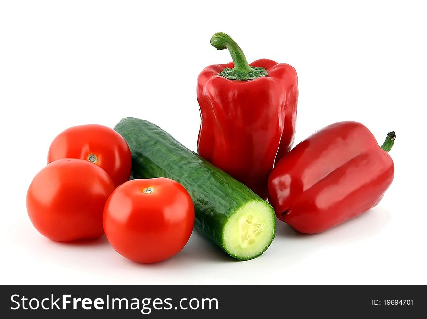 Red pepper, tomato and cucumber on a white background. Red pepper, tomato and cucumber on a white background