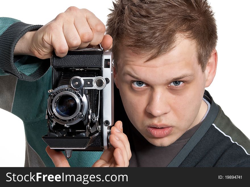 A young man is focused photographing old camera