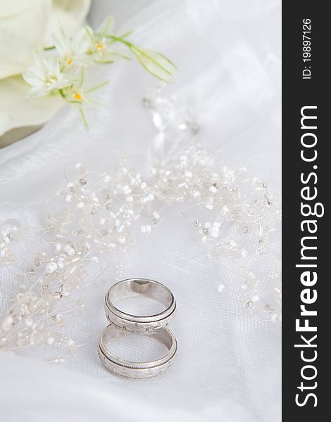 Wedding rings and beads on a veil
