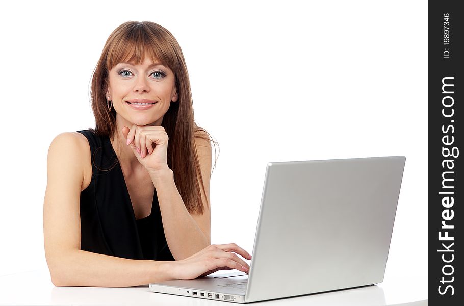 Woman with a smile on his face and a laptop computer on the desk, isolated background. Woman with a smile on his face and a laptop computer on the desk, isolated background