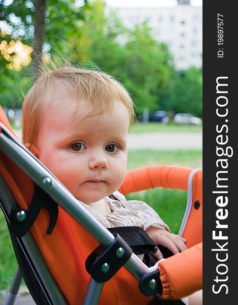 1 year old girl sitting in baby carriage. 1 year old girl sitting in baby carriage