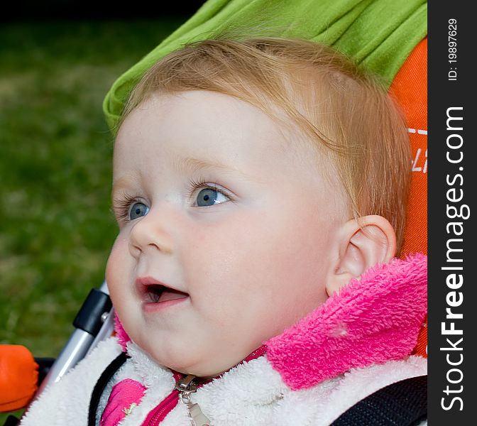 1 year old girl sitting in baby carriage. 1 year old girl sitting in baby carriage