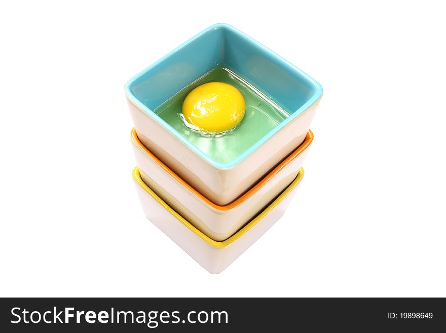 Raw egg in stack bowl isolated on white background
