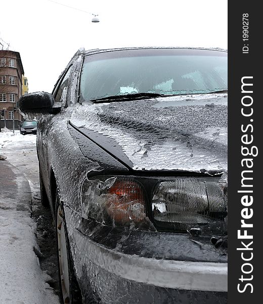 Portrait of modern car covered in ice. Portrait of modern car covered in ice