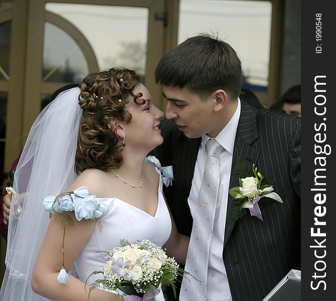 The groom kisses the bride