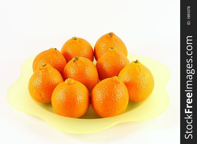 Isolated photo of of tangerine or orange on green plate. Isolated photo of of tangerine or orange on green plate
