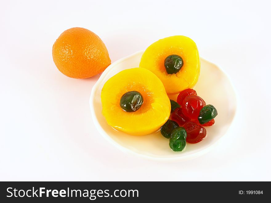 Isolated photo of fruits selections peach orange and glaced cherries