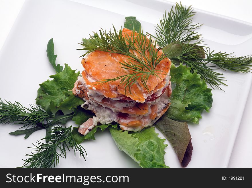 Smoked salmon with creamy cheese on a white plate