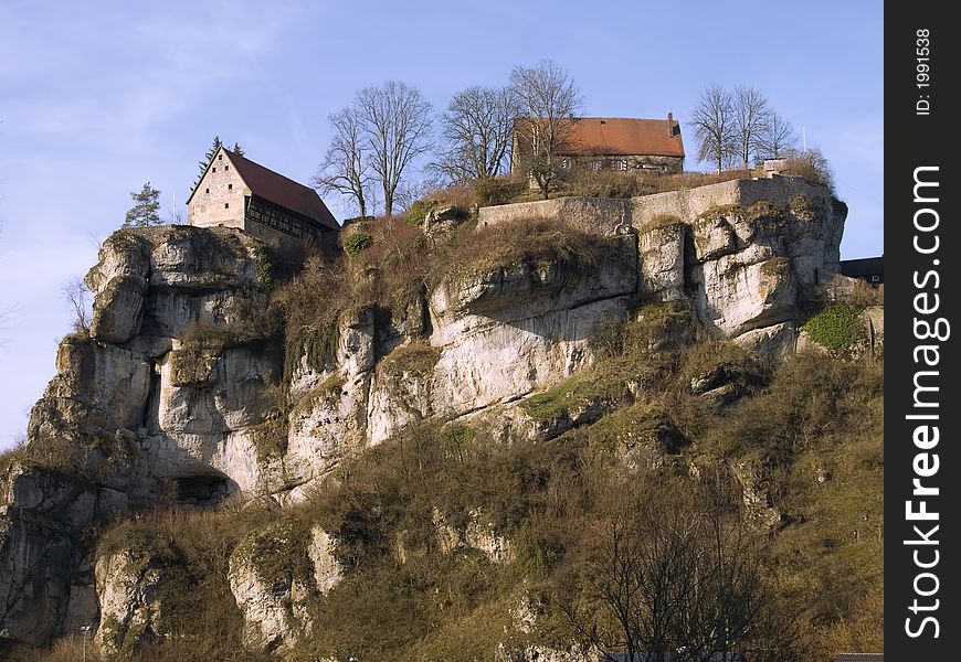 Bavarian castle on a steep and rocky hill in the evening sun. Bavarian castle on a steep and rocky hill in the evening sun