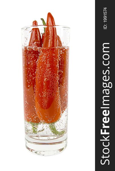 Three Red Peppers in The Glass of Bubbled Water. Isolated on White in Studio. Three Red Peppers in The Glass of Bubbled Water. Isolated on White in Studio.