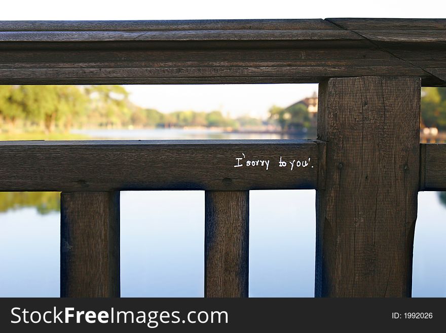 Sorry message on a wooden fence