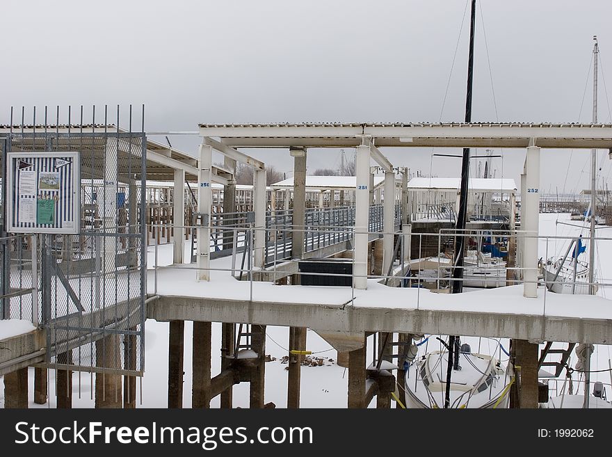 This image is a cold snowy setting of the local boat docks around central Oklahoma, looks like a good time for a vacation to a warmer climate. This image is a cold snowy setting of the local boat docks around central Oklahoma, looks like a good time for a vacation to a warmer climate.