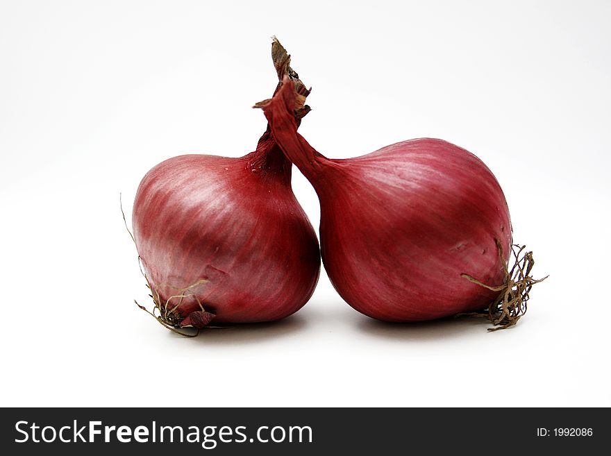 Two onions isolated on white surface