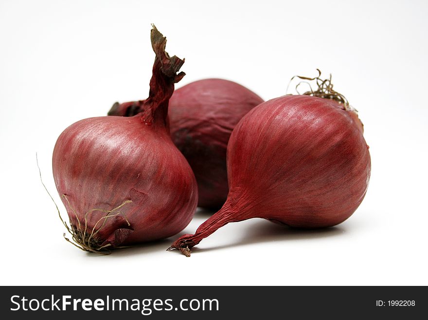 Three onions isolated on white surface