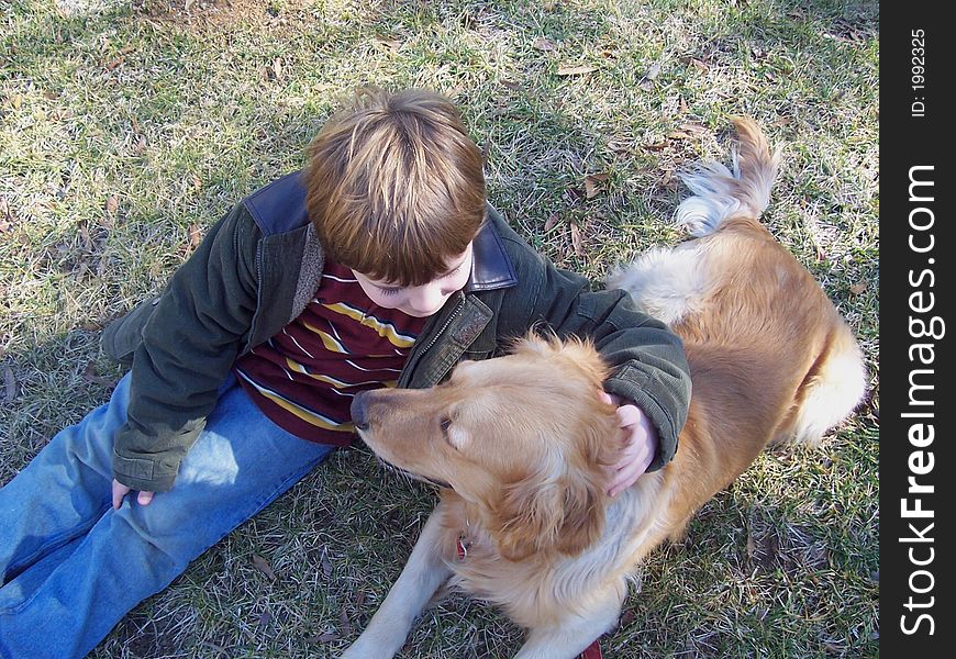 Boy and dog playing in field