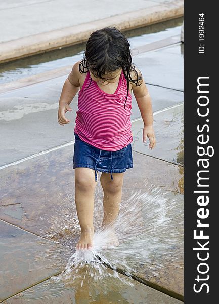 Summer fun at a downtown fountain with jet of water time to spray up at any time. Summer fun at a downtown fountain with jet of water time to spray up at any time.