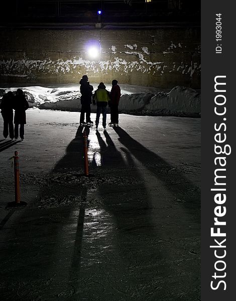 Night image of three backlighted skaters. Night image of three backlighted skaters