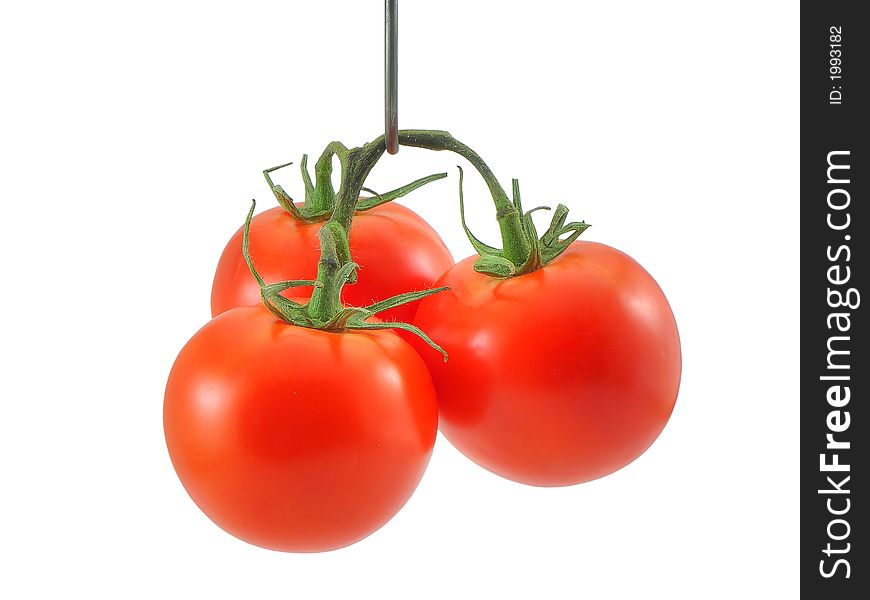 Photo of three hanging tomatoes isolated on white