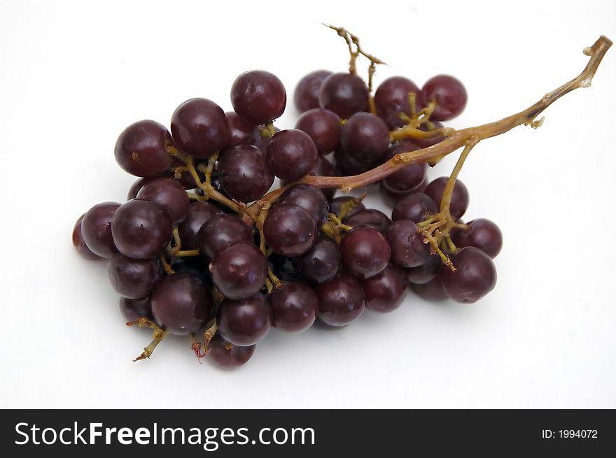 A bunch of grapes isolated against a white background