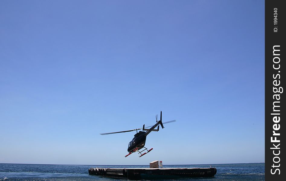 Helicopter take off over the Great Barrier Reef in Australia. Helicopter take off over the Great Barrier Reef in Australia