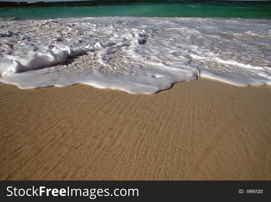 Retreating wave and wet sand. Retreating wave and wet sand