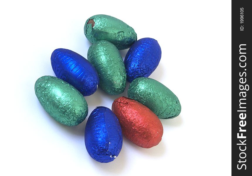 Chocolate easter eggs with coloured foil in a pile. Chocolate easter eggs with coloured foil in a pile