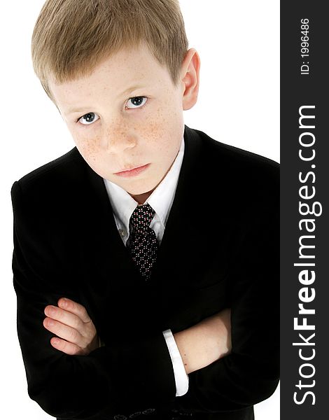 Little boy dressed in a suit; arms crossed with serious expression. Little boy dressed in a suit; arms crossed with serious expression