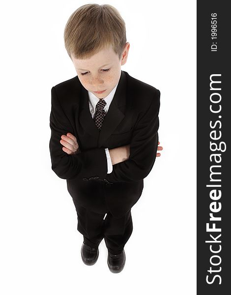 Little boy dressed in a suit looking down with serious expression. Little boy dressed in a suit looking down with serious expression