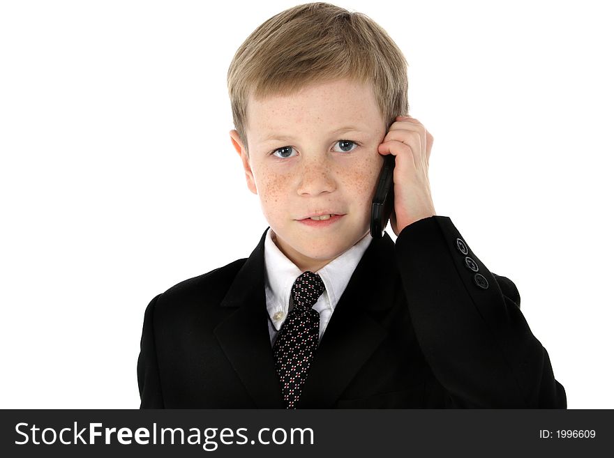 Little boy dressed in a suit talking on cell phone. Little boy dressed in a suit talking on cell phone