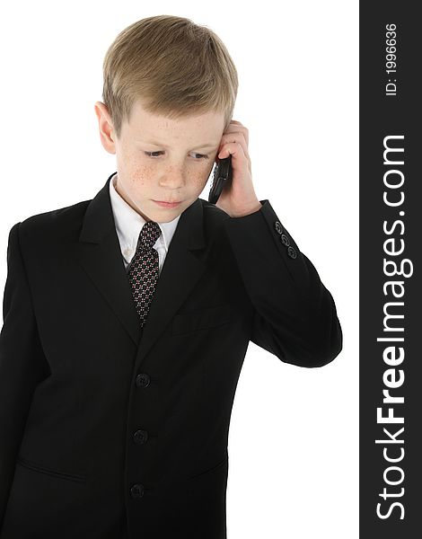 Little boy dressed in a suit talking on cell phone. Little boy dressed in a suit talking on cell phone